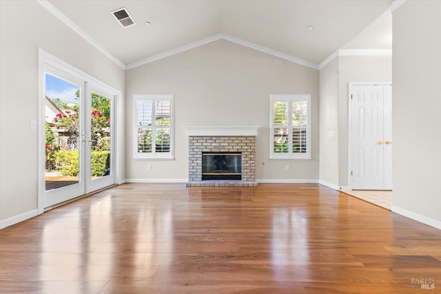 843 Cab Calloway Ct, Windsor, CA 95492 - unfurnished living room featuring wood finished floors, plenty of natural light, lofted ceiling, a brick fireplace, and ornamental molding