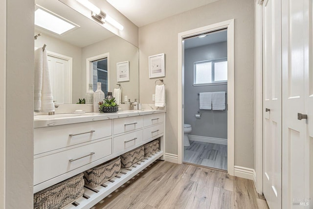 37 Angela Ave, San Anselmo, CA 94960 - bathroom featuring double vanity, toilet, wood finished floors, baseboards, and a closet
