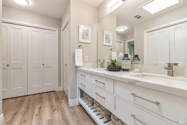 37 Angela Ave, San Anselmo, CA 94960 - full bathroom featuring a closet, double vanity, wood finished floors, and baseboards