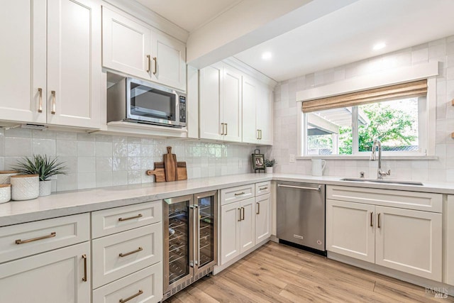 37 Angela Ave, San Anselmo, CA 94960 - kitchen featuring stainless steel appliances, wine cooler, a sink, white cabinets, and backsplash