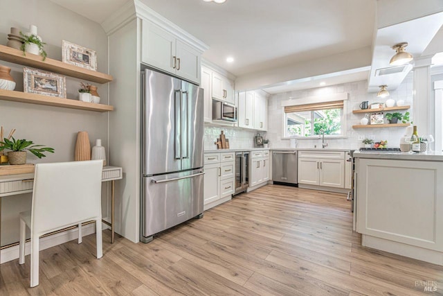 37 Angela Ave, San Anselmo, CA 94960 - kitchen with stainless steel appliances, open shelves, wine cooler, tasteful backsplash, and light wood-type flooring