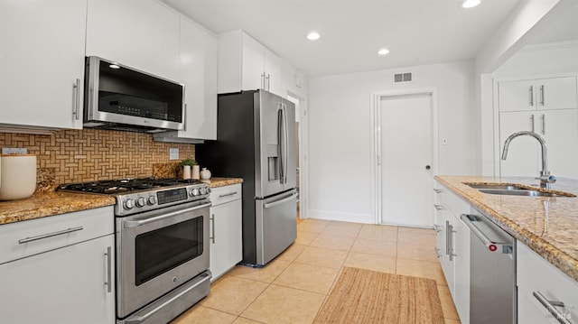 40 Staghound Psge, Corte Madera, CA 94925 - kitchen with appliances with stainless steel finishes, a sink, tasteful backsplash, white cabinetry, and light tile patterned floors