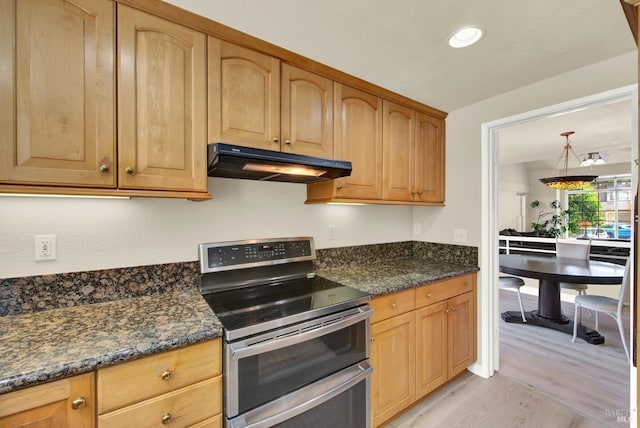 3327 Colonial Ct, Fairfield, CA 94534 - kitchen with under cabinet range hood, range with two ovens, light wood finished floors, dark stone counters, and recessed lighting