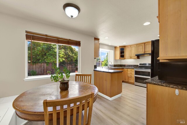 3327 Colonial Ct, Fairfield, CA 94534 - kitchen with range with two ovens, a sink, glass insert cabinets, light wood finished floors, and recessed lighting