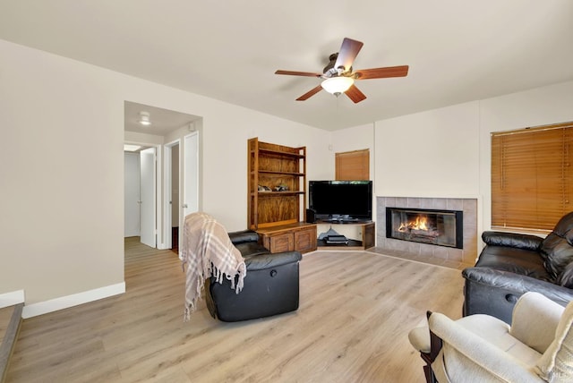 3327 Colonial Ct, Fairfield, CA 94534 - living area featuring light wood finished floors, a ceiling fan, a tile fireplace, and baseboards