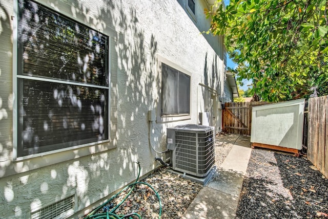 3327 Colonial Ct, Fairfield, CA 94534 - exterior view of central AC unit, stucco siding, and a gate