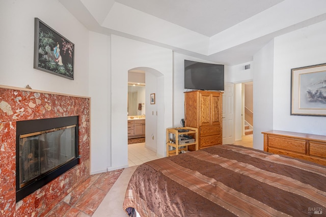 2016 Stonefield Ln, Santa Rosa, CA 95403 - bedroom featuring arched walkways, a fireplace, light tile patterned floors, and connected bathroom