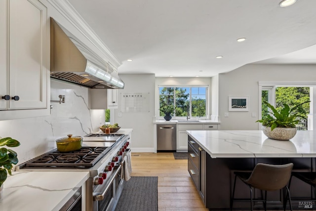 6 Live Oak Way, San Rafael, CA 94901 - kitchen featuring custom exhaust hood, appliances with stainless steel finishes, light wood finished floors, white cabinetry, and light stone countertops