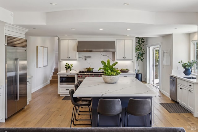 6 Live Oak Way, San Rafael, CA 94901 - kitchen with high end appliances, under cabinet range hood, a sink, light stone countertops, and baseboards