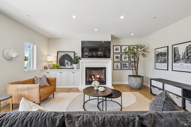 6 Live Oak Way, San Rafael, CA 94901 - living area with light wood-style flooring, a glass covered fireplace, recessed lighting, and baseboards