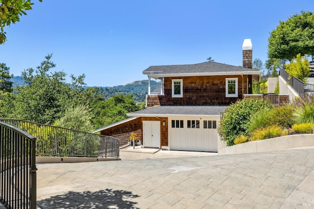 6 Live Oak Way, San Rafael, CA 94901 - view of side of home with a chimney, a garage, a shingled roof, and driveway