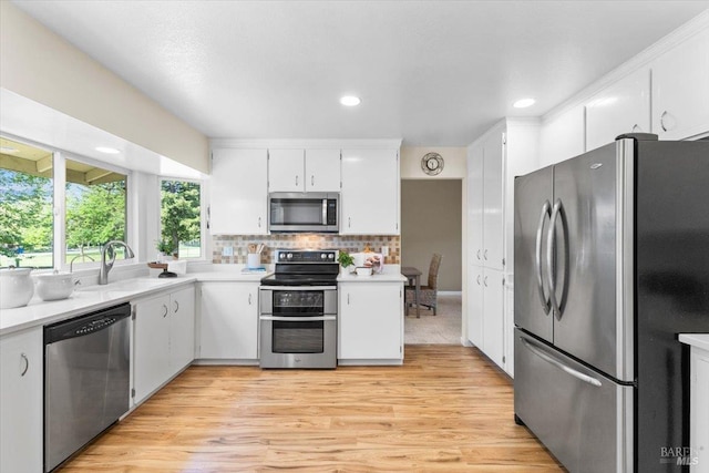 1503 Galaxy Ct, Rohnert Park, CA 94928 - kitchen featuring stainless steel appliances, a sink, light countertops, white cabinets, and light wood-style floors