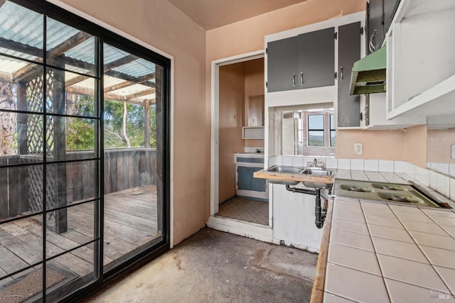 2840 Pear View Rd, Lakeport, CA 95453 - kitchen featuring tile counters, concrete floors, under cabinet range hood, and a sink