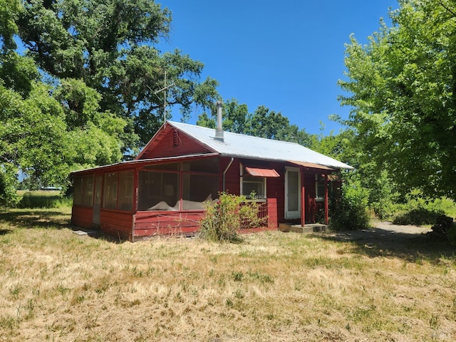 25500 Fairbanks Ln, Covelo, CA 95428 - view of front of house featuring a front lawn, a sunroom, and metal roof