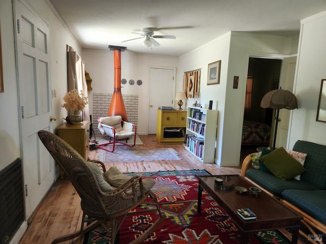 25500 Fairbanks Ln, Covelo, CA 95428 - living area featuring hardwood / wood-style flooring, ceiling fan, a wood stove, and crown molding