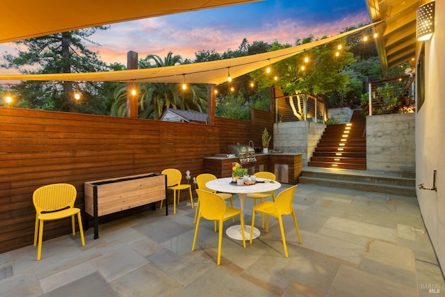 55 Durham Rd, San Anselmo, CA 94960 - patio terrace at dusk featuring outdoor dining space, stairway, and a patio