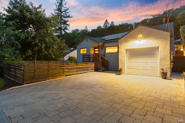 55 Durham Rd, San Anselmo, CA 94960 - view of front of property with a garage, solar panels, stucco siding, and decorative driveway