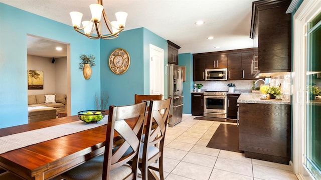 1523 Bruce Ct, Santa Rosa, CA 95401 - kitchen with stainless steel appliances, dark brown cabinetry, light tile patterned floors, a chandelier, and decorative light fixtures