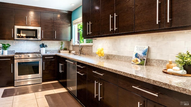 1523 Bruce Ct, Santa Rosa, CA 95401 - kitchen with appliances with stainless steel finishes, a sink, light tile patterned floors, light stone countertops, and dark brown cabinets