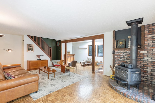 4011 Mill Creek Rd, Healdsburg, CA 95448 - living room featuring a wood stove, an AC wall unit, stairs, and a textured ceiling
