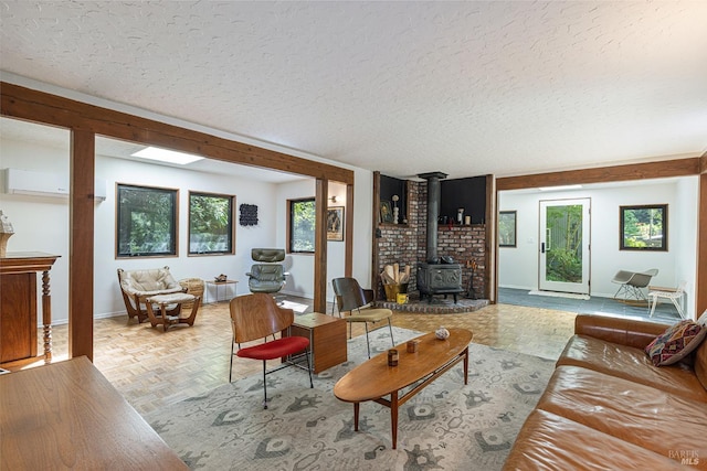 4011 Mill Creek Rd, Healdsburg, CA 95448 - living room featuring a wood stove, a textured ceiling, and baseboards