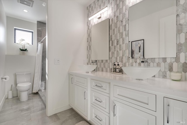 1994 W Bristlecone Ct, Santa Rosa, CA 95403 - full bathroom featuring a shower with shower curtain, decorative backsplash, baseboards, double vanity, and toilet