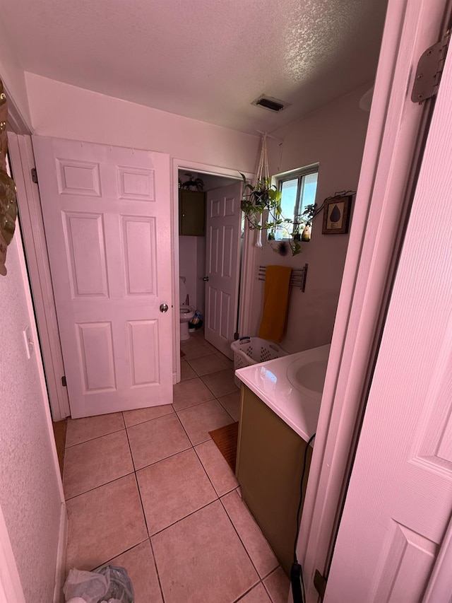 561 Samuel Way, Sacramento, CA 95838 - bathroom featuring vanity, tile patterned flooring, a textured ceiling, and toilet