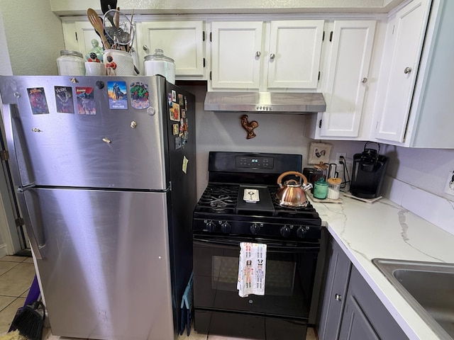 561 Samuel Way, Sacramento, CA 95838 - kitchen with freestanding refrigerator, black range with gas stovetop, extractor fan, and white cabinetry