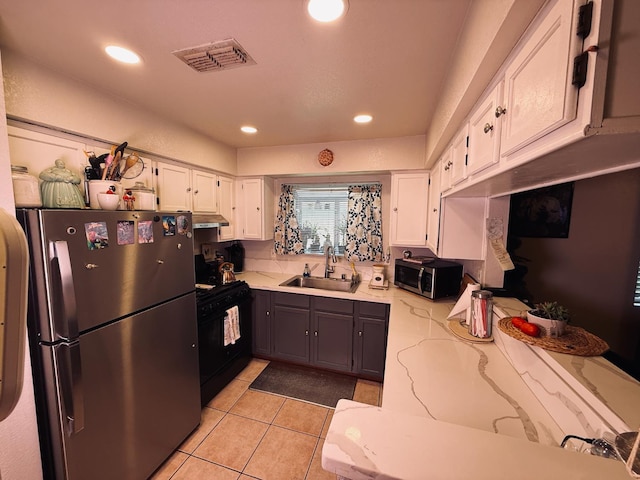561 Samuel Way, Sacramento, CA 95838 - kitchen with appliances with stainless steel finishes, a sink, under cabinet range hood, white cabinetry, and light stone counters