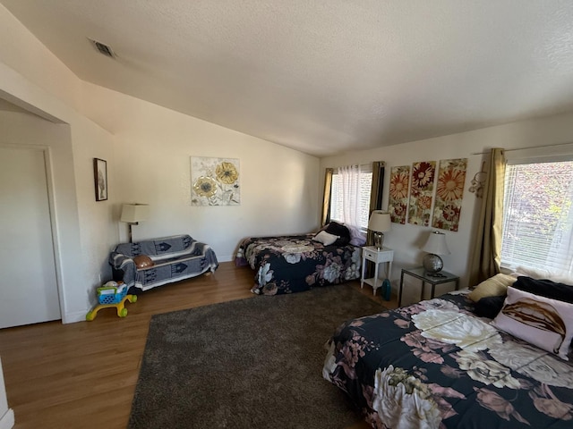 561 Samuel Way, Sacramento, CA 95838 - bedroom featuring vaulted ceiling, wood finished floors, and a textured ceiling