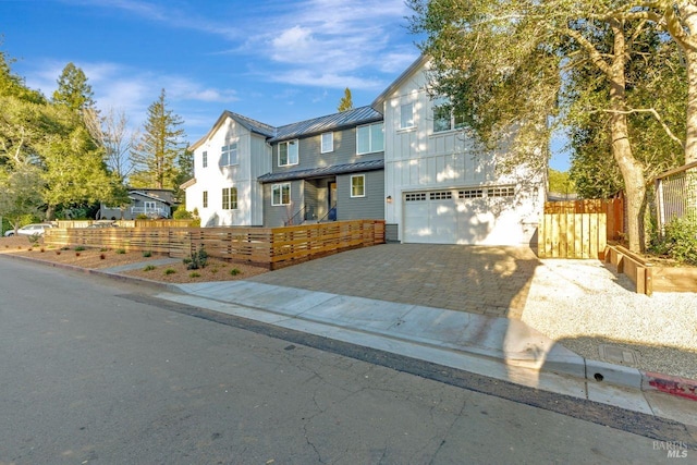 22 Cedar Ave, Kentfield, CA 94904 - view of front of home featuring a standing seam roof, decorative driveway, a garage, board and batten siding, and metal roof