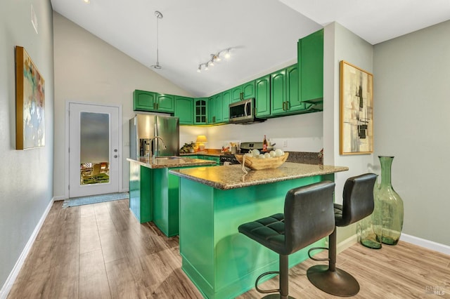 1753 15th St, San Pablo, CA 94806 - kitchen featuring green cabinetry, stainless steel appliances, a peninsula, light wood-style flooring, and vaulted ceiling