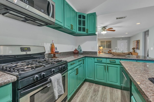 1753 15th St, San Pablo, CA 94806 - kitchen featuring stainless steel appliances, green cabinetry, light wood-style flooring, a ceiling fan, and glass insert cabinets