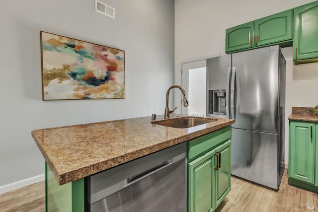 1753 15th St, San Pablo, CA 94806 - kitchen featuring appliances with stainless steel finishes, green cabinetry, a sink, and light wood-style floors