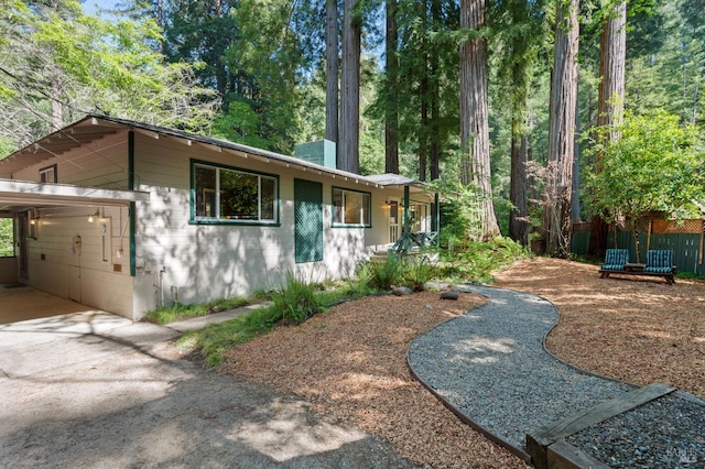5600 Cazadero Hwy, Cazadero, CA 95421 - view of front of property with concrete block siding, concrete driveway, and a chimney