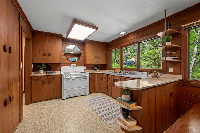 5600 Cazadero Hwy, Cazadero, CA 95421 - kitchen featuring open shelves, white range with gas cooktop, brown cabinets, light countertops, and wooden walls
