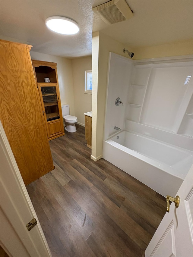 612 Union St, Isleton, CA 95641 - bathroom featuring toilet, baseboards, washtub / shower combination, wood finished floors, and vanity