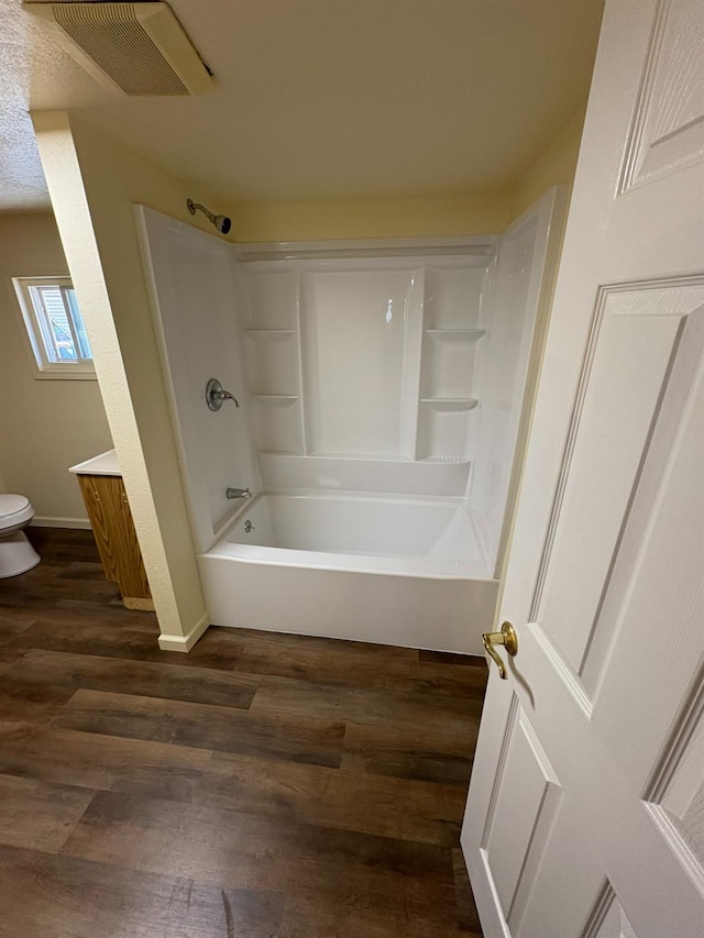 612 Union St, Isleton, CA 95641 - bathroom featuring toilet, wood finished floors, shower / bath combination, vanity, and baseboards
