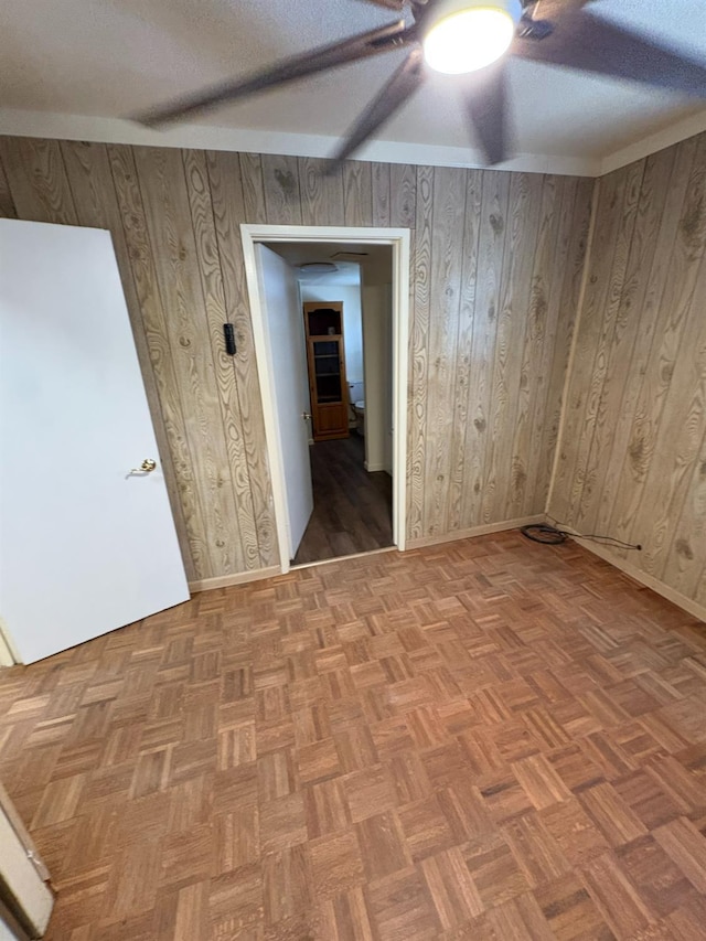 612 Union St, Isleton, CA 95641 - spare room with a ceiling fan, a textured ceiling, and wooden walls