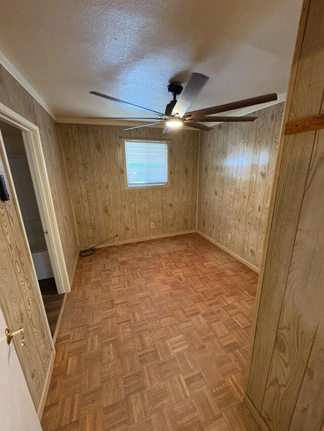 612 Union St, Isleton, CA 95641 - empty room with ceiling fan, baseboards, a textured ceiling, and wood walls