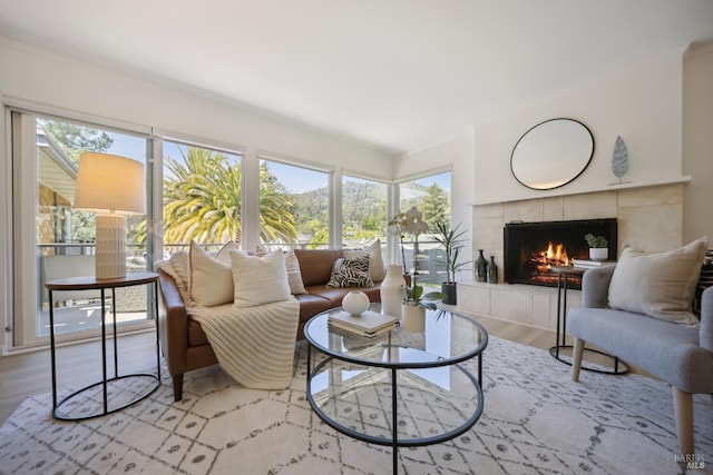 40 Redwood Ave, Corte Madera, CA 94925 - living area featuring a tile fireplace, healthy amount of natural light, wood finished floors, and crown molding