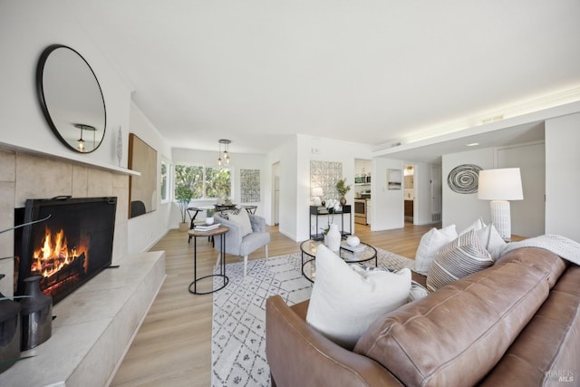 40 Redwood Ave, Corte Madera, CA 94925 - living room with a tile fireplace, light wood-style flooring, and baseboards