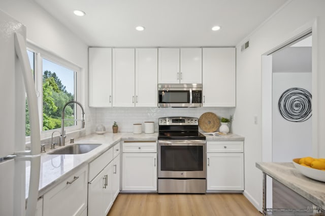 40 Redwood Ave, Corte Madera, CA 94925 - kitchen featuring appliances with stainless steel finishes, a sink, white cabinets, and recessed lighting