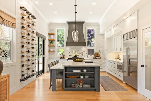 943 Appleridge Pl, Fairfield, CA 94534 - kitchen featuring open shelves, built in refrigerator, custom range hood, light wood finished floors, and recessed lighting