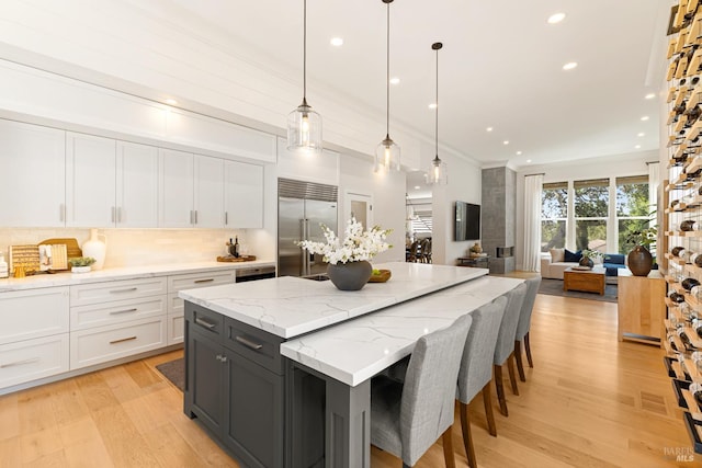 943 Appleridge Pl, Fairfield, CA 94534 - kitchen featuring stainless steel built in refrigerator, backsplash, white cabinetry, light wood finished floors, and recessed lighting