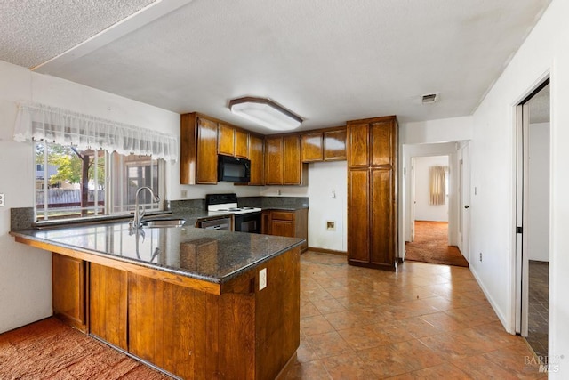 1417 Klamath Dr, Suisun City, CA 94585 - kitchen with black microwave, a sink, electric range, brown cabinets, and a peninsula