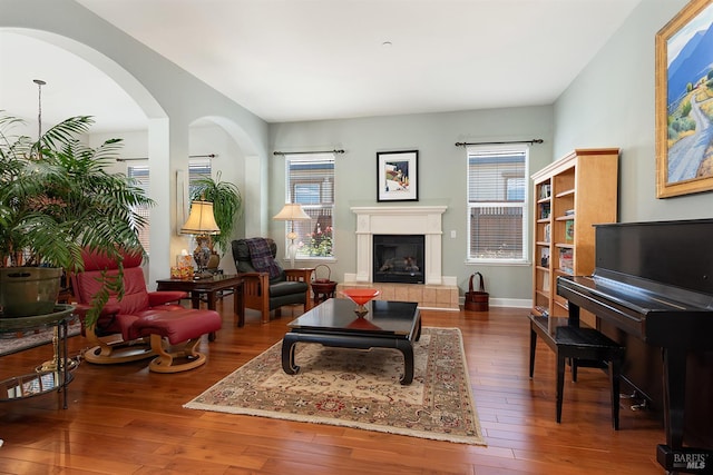 8596 Starr Rd, Windsor, CA 95492 - living area featuring wood-type flooring, a tiled fireplace, and baseboards