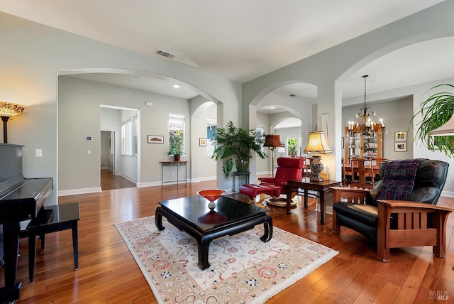 8596 Starr Rd, Windsor, CA 95492 - living room with light wood-type flooring, arched walkways, recessed lighting, baseboards, and a chandelier