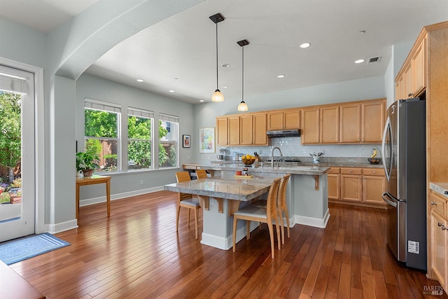 8596 Starr Rd, Windsor, CA 95492 - kitchen with freestanding refrigerator, light brown cabinetry, a kitchen breakfast bar, tasteful backsplash, and dark wood-style floors