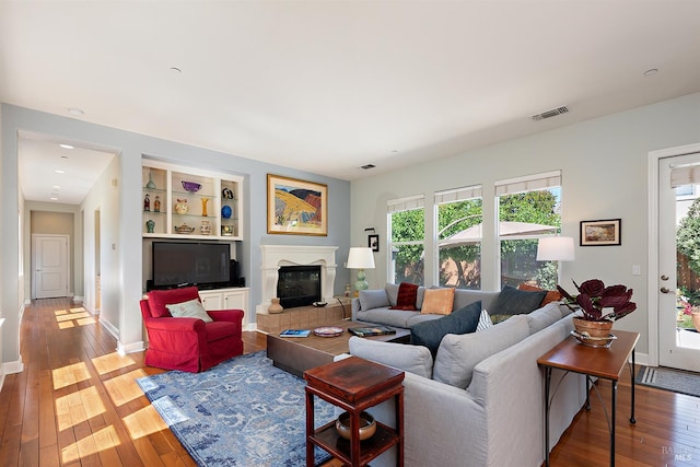 8596 Starr Rd, Windsor, CA 95492 - living area with plenty of natural light, wood-type flooring, and a glass covered fireplace